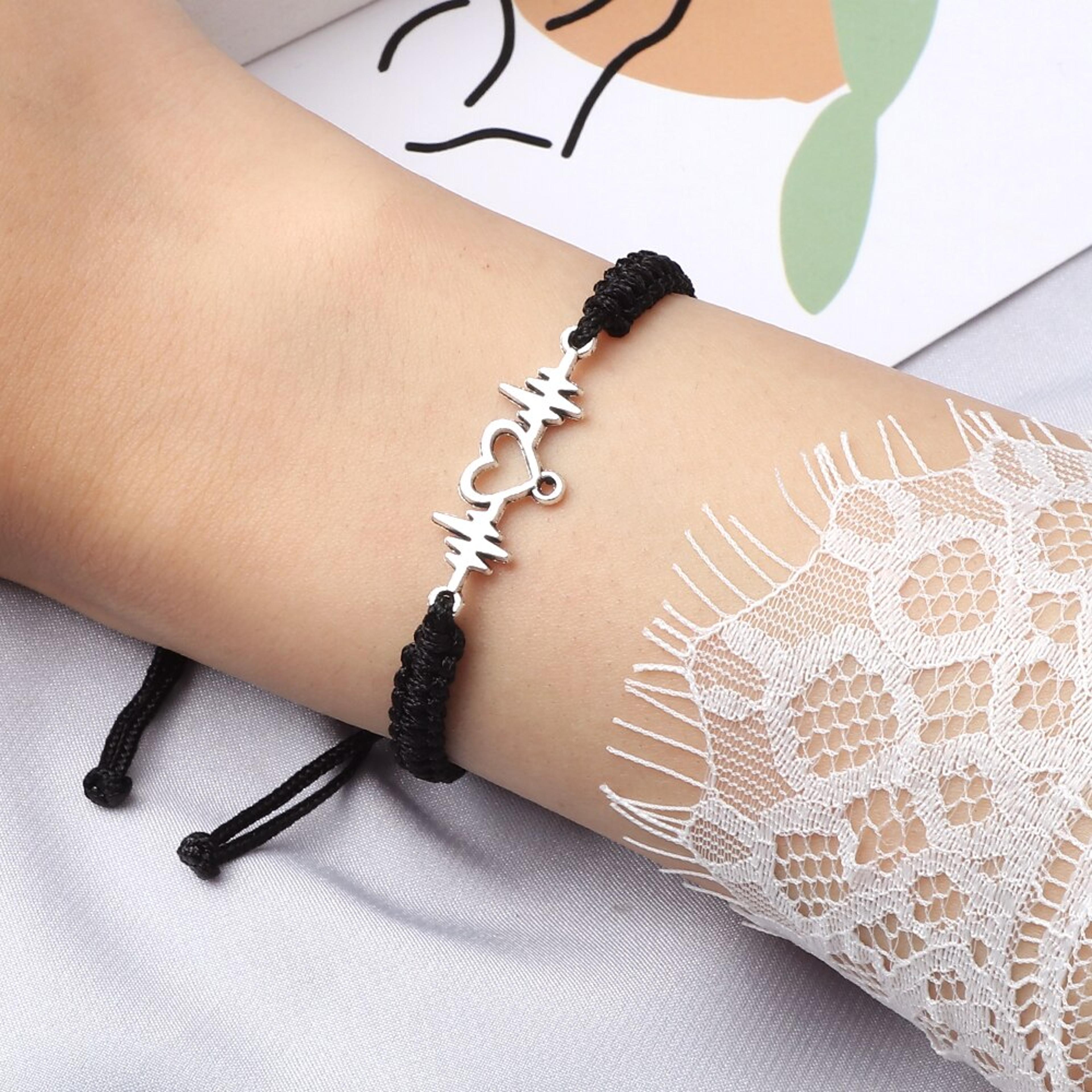 couples heartbeat bracelet with a heart shaped charm