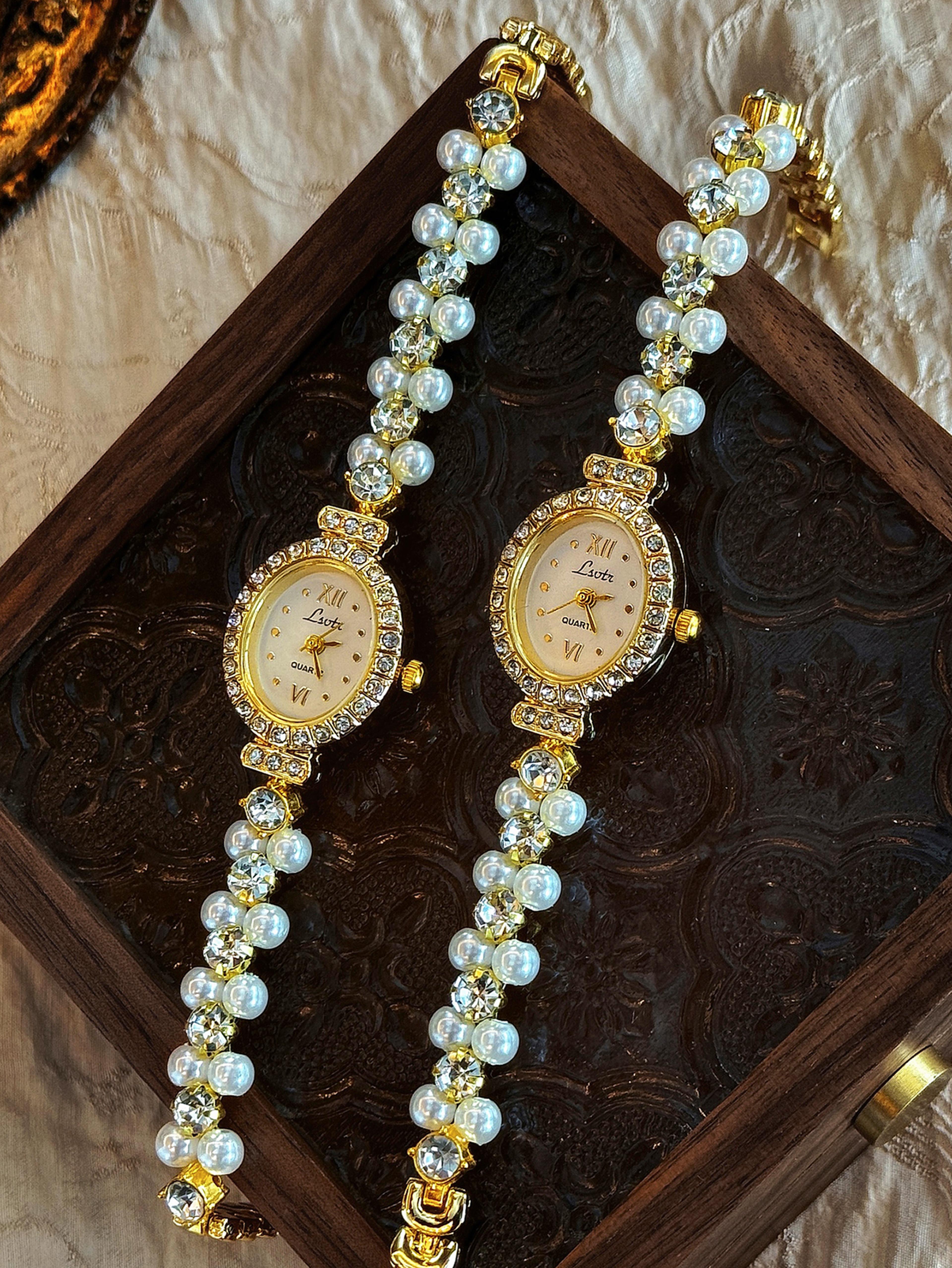 luxury women's pearl watch with oval mother of pearl dial & rhinestone bracelet