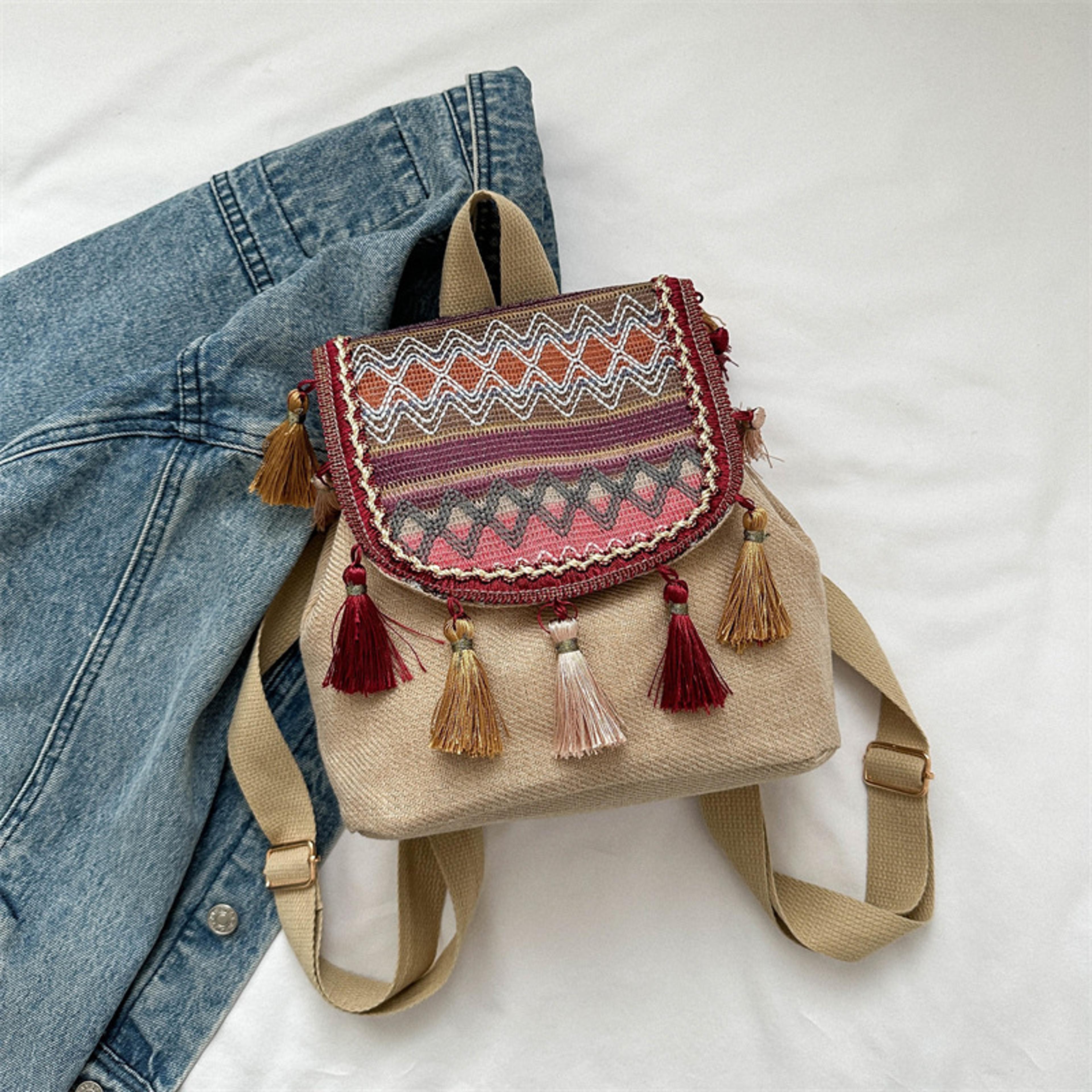 bohemian straw backpack with playful tassels & drawstring closure
