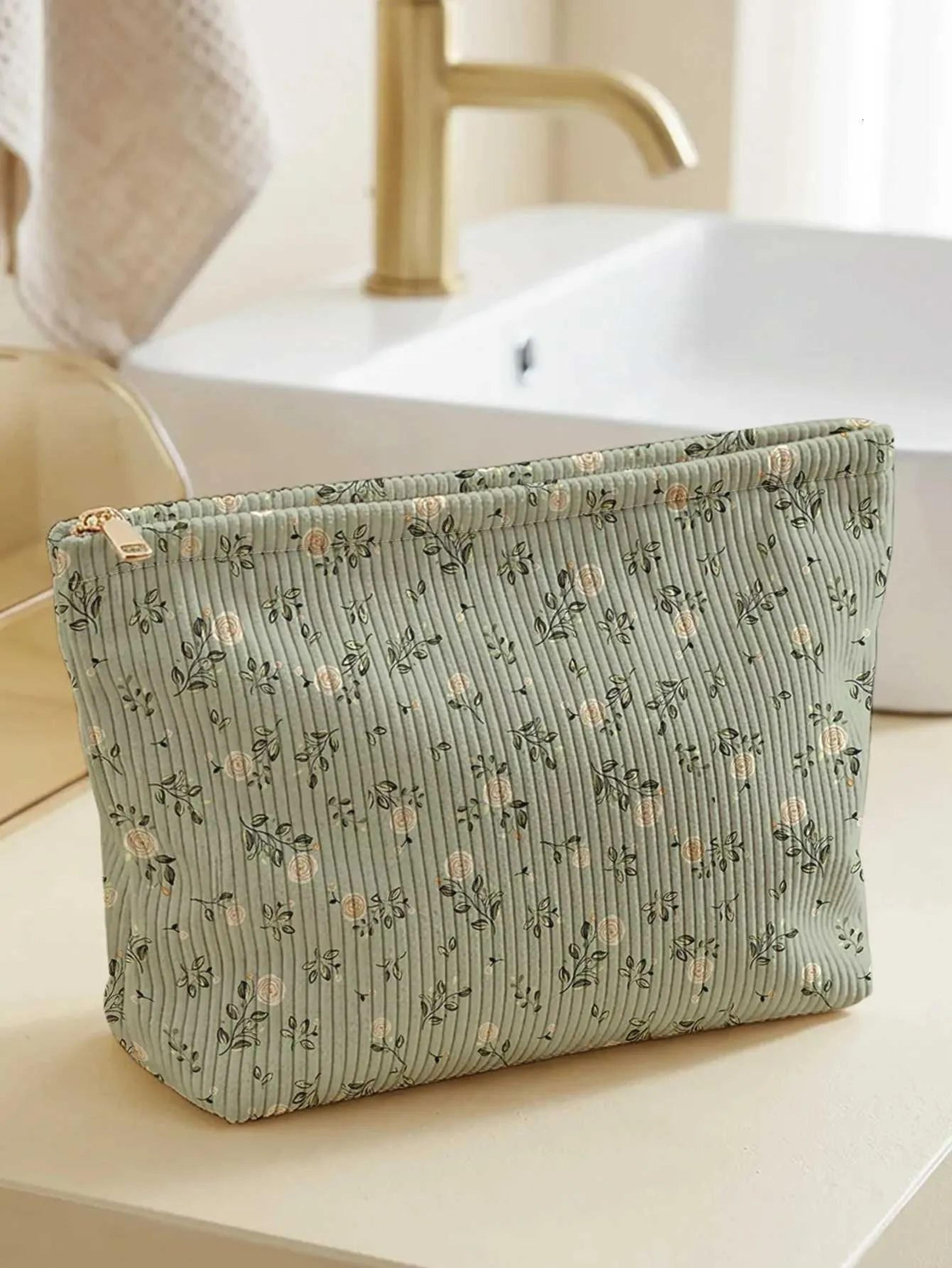 floral corduroy makeup bag with white rose print and zipper closure