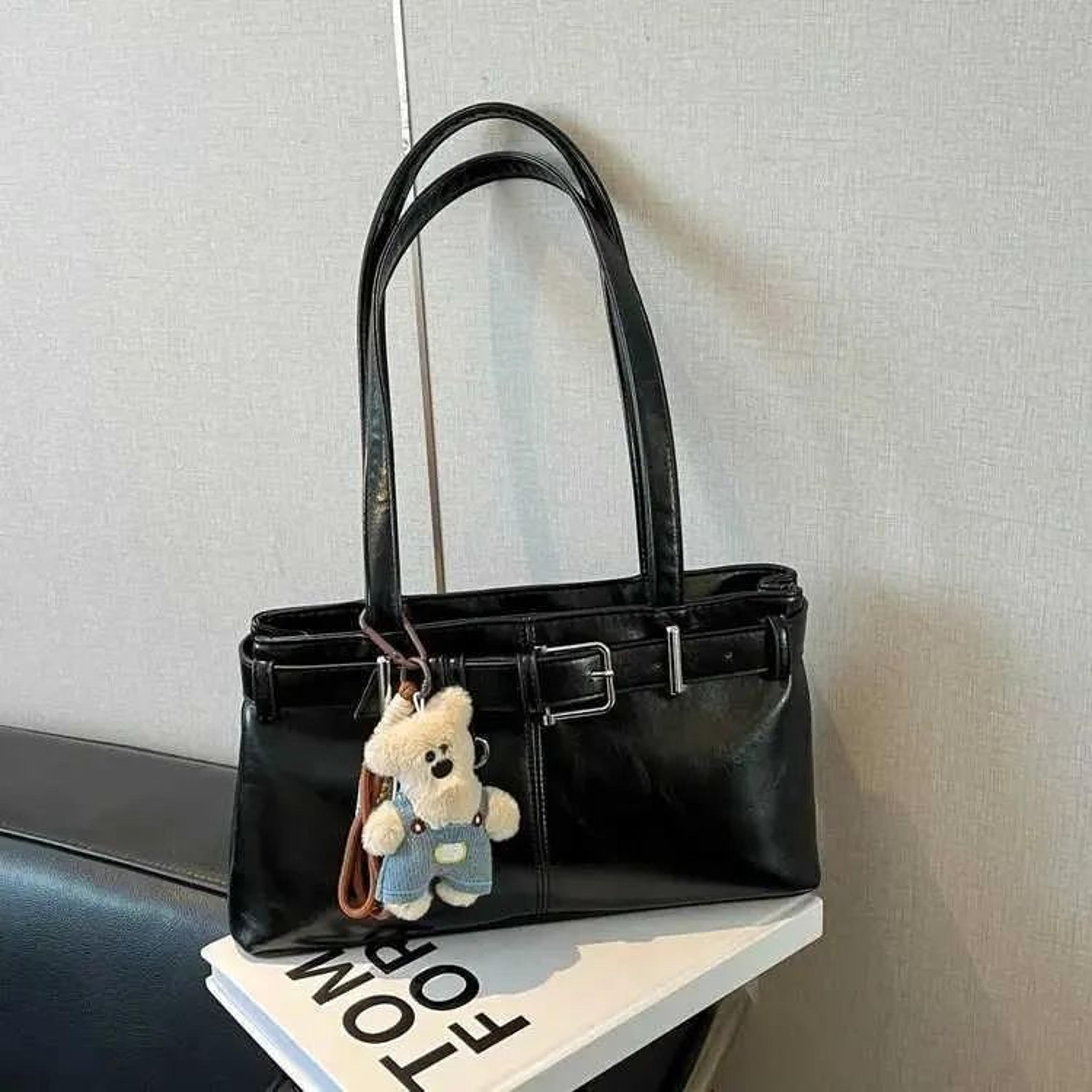 women leather shoulder bag with belt detail and teddy bear accent
