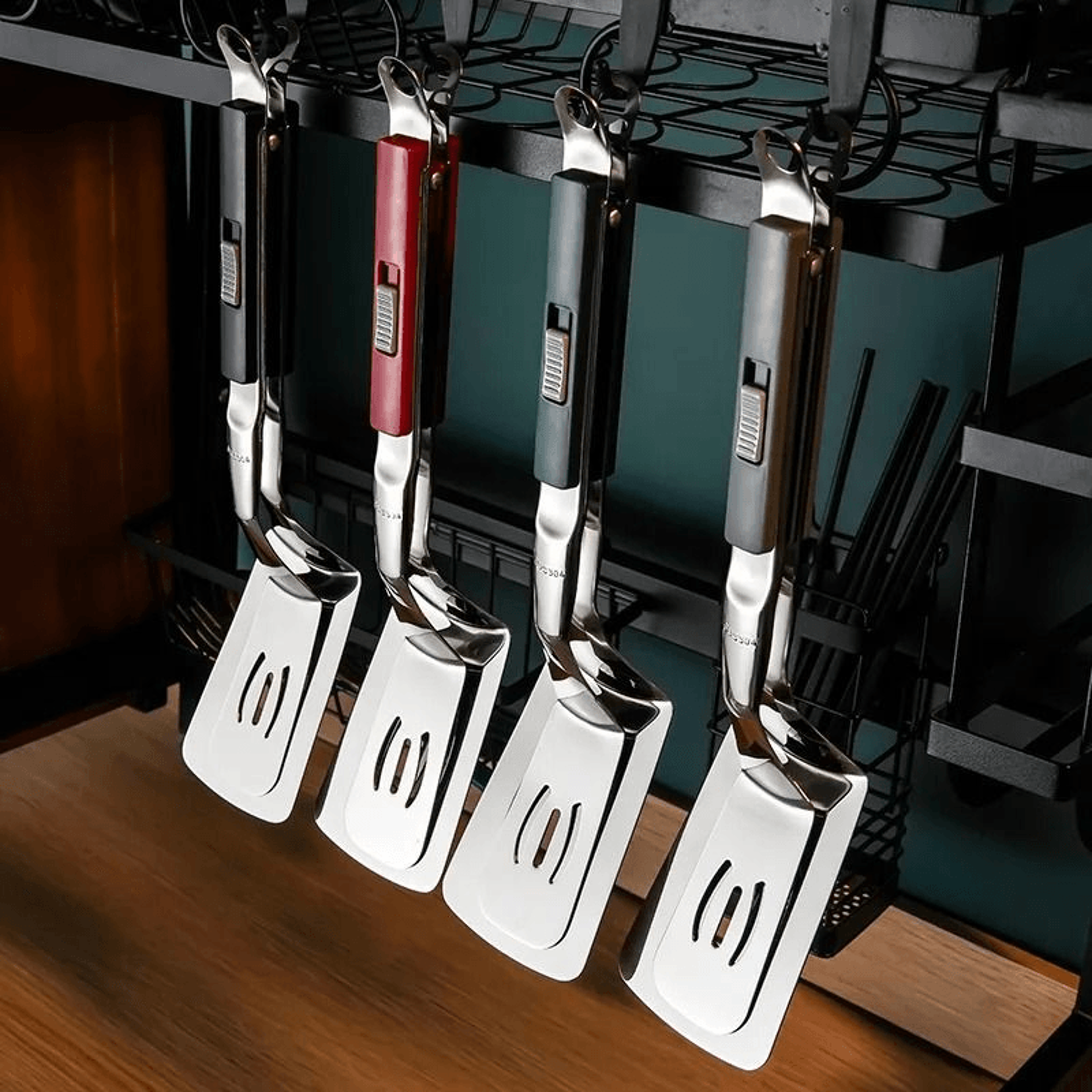 slotted spatula tongs draining oil while lifting food