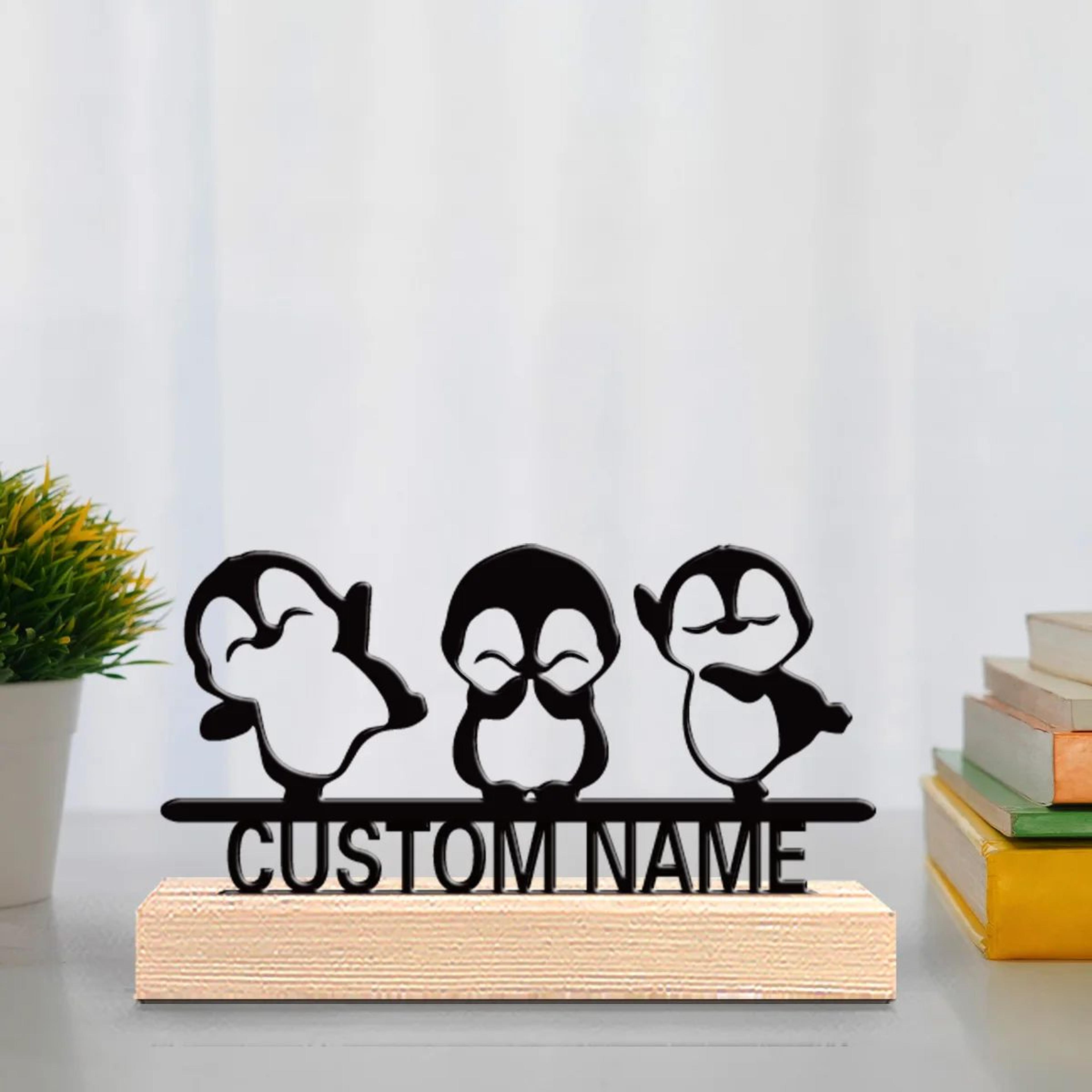 cute penguin metal statue trio with wooden base