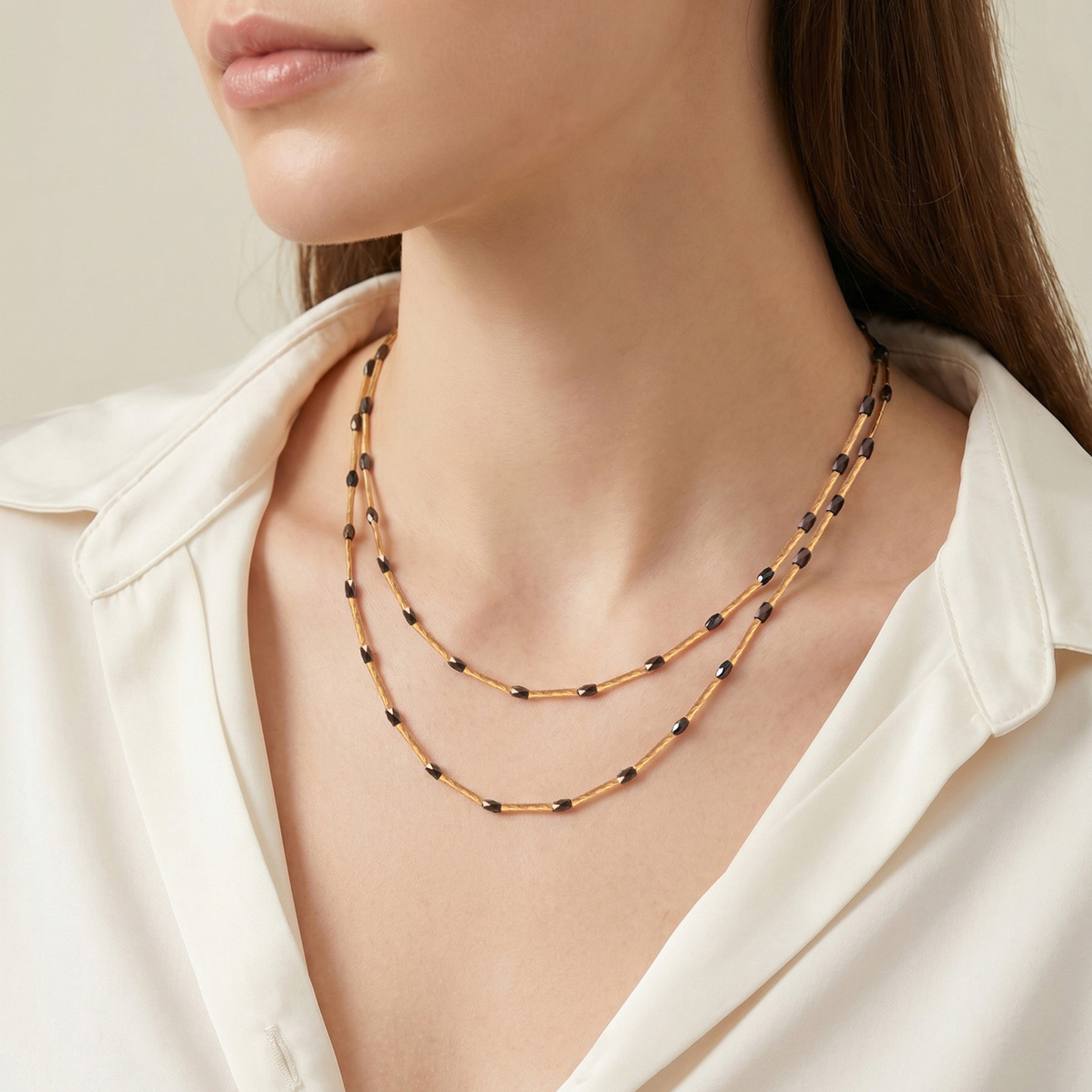 Gold beaded layered necklace with black rice beads