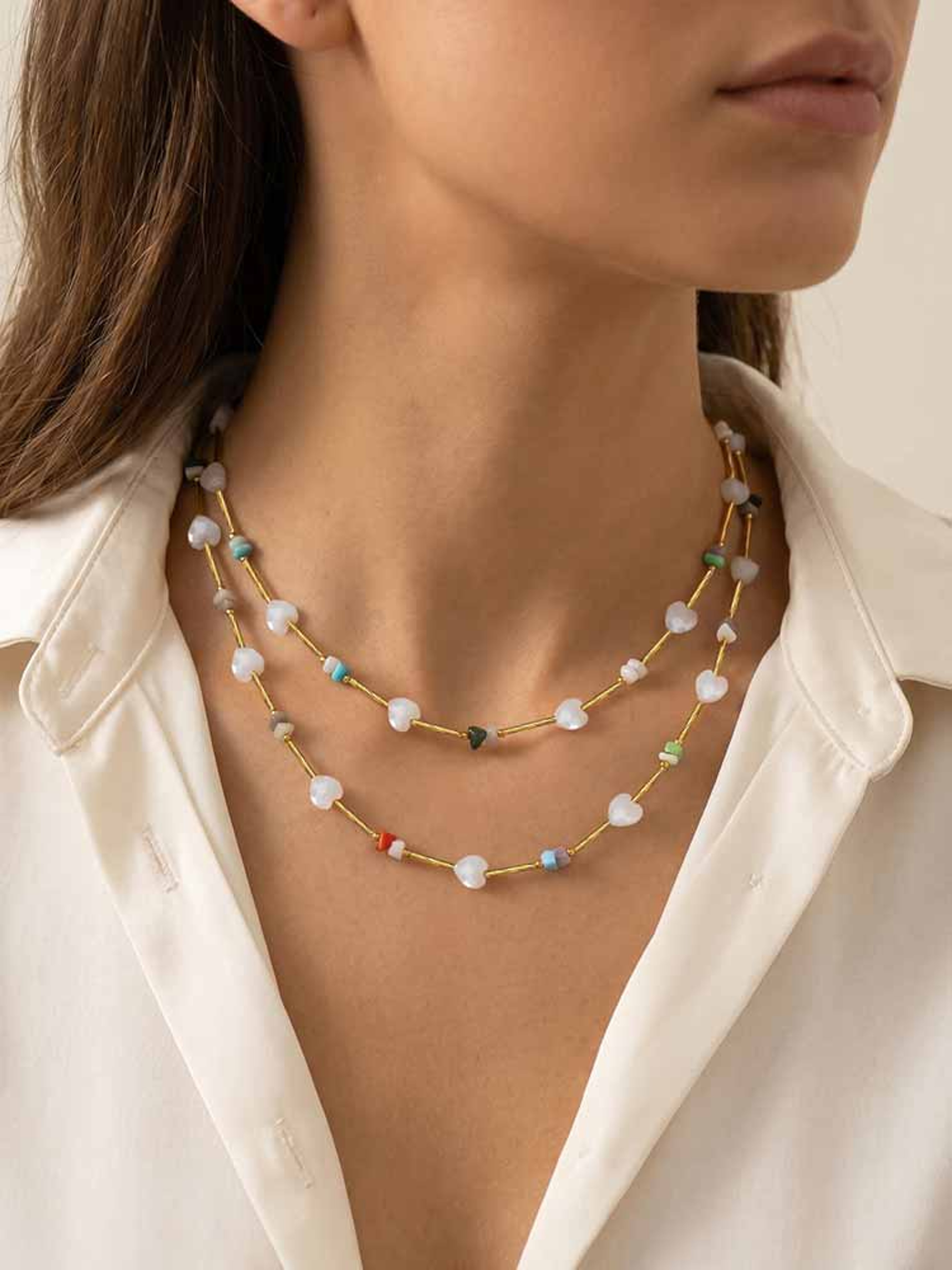 Gold beaded layered necklace with white heart beads