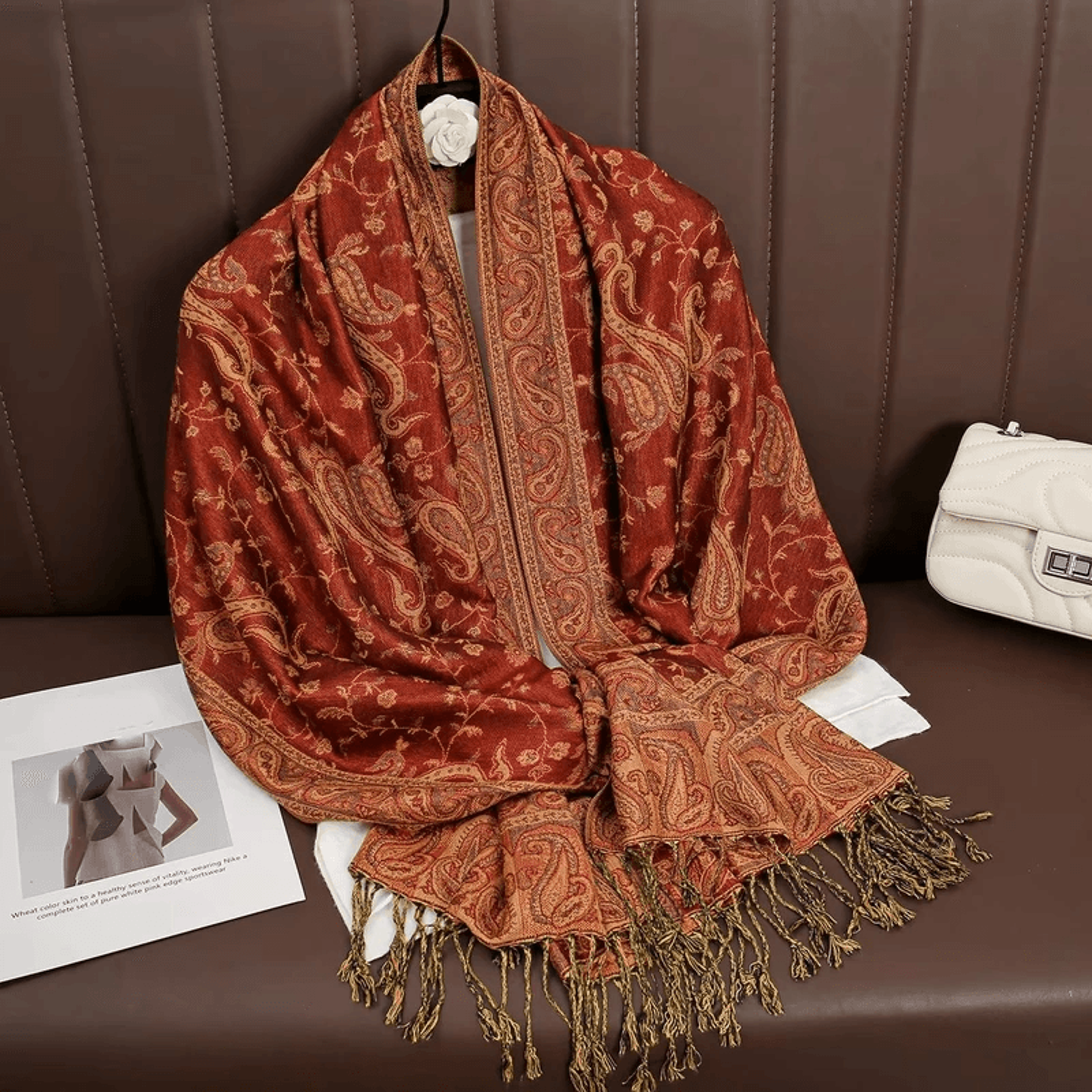soft travel wrap scarf resting on airplane seat for warmth