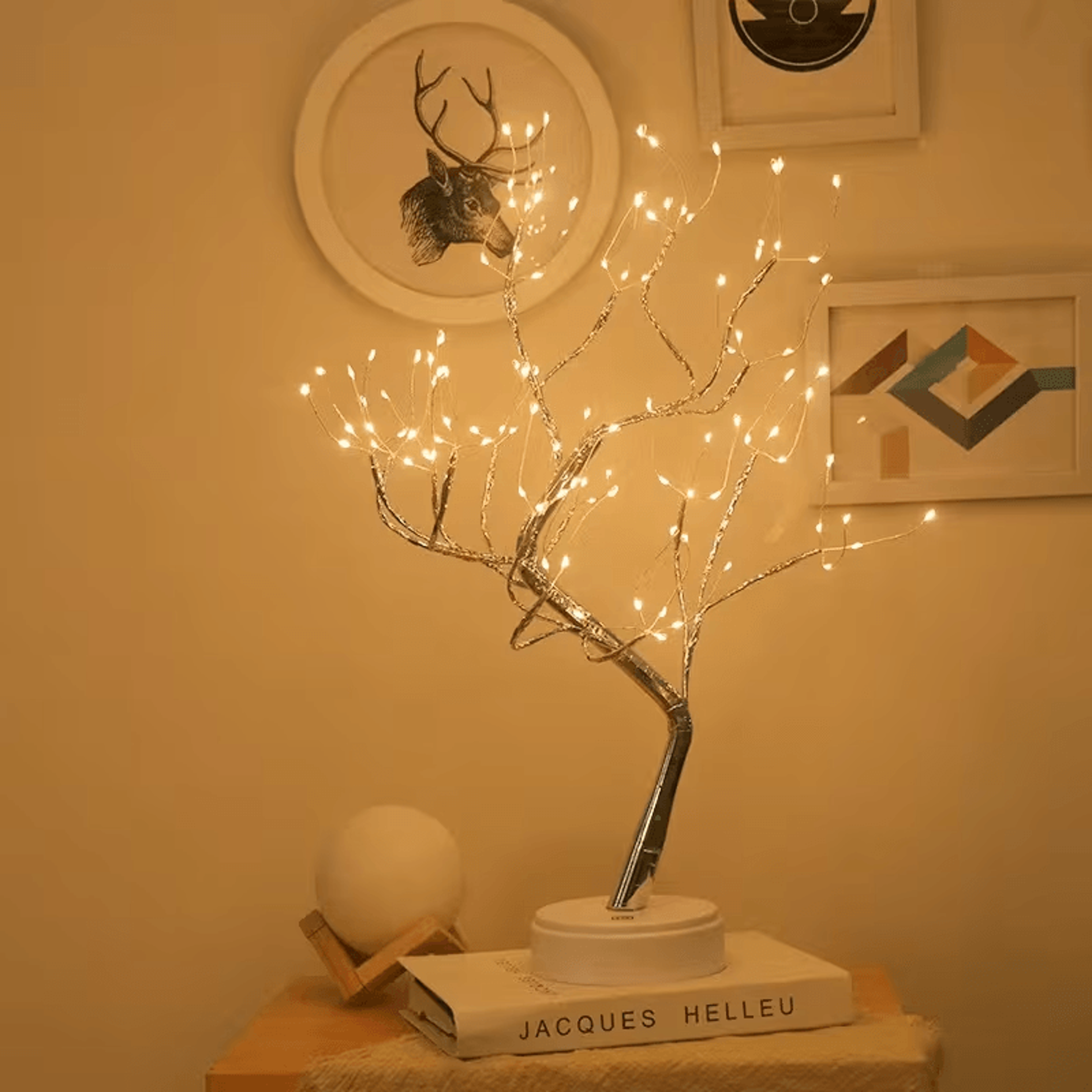 Fairy Light Tree Lamp glowing next to a comfortable armchair