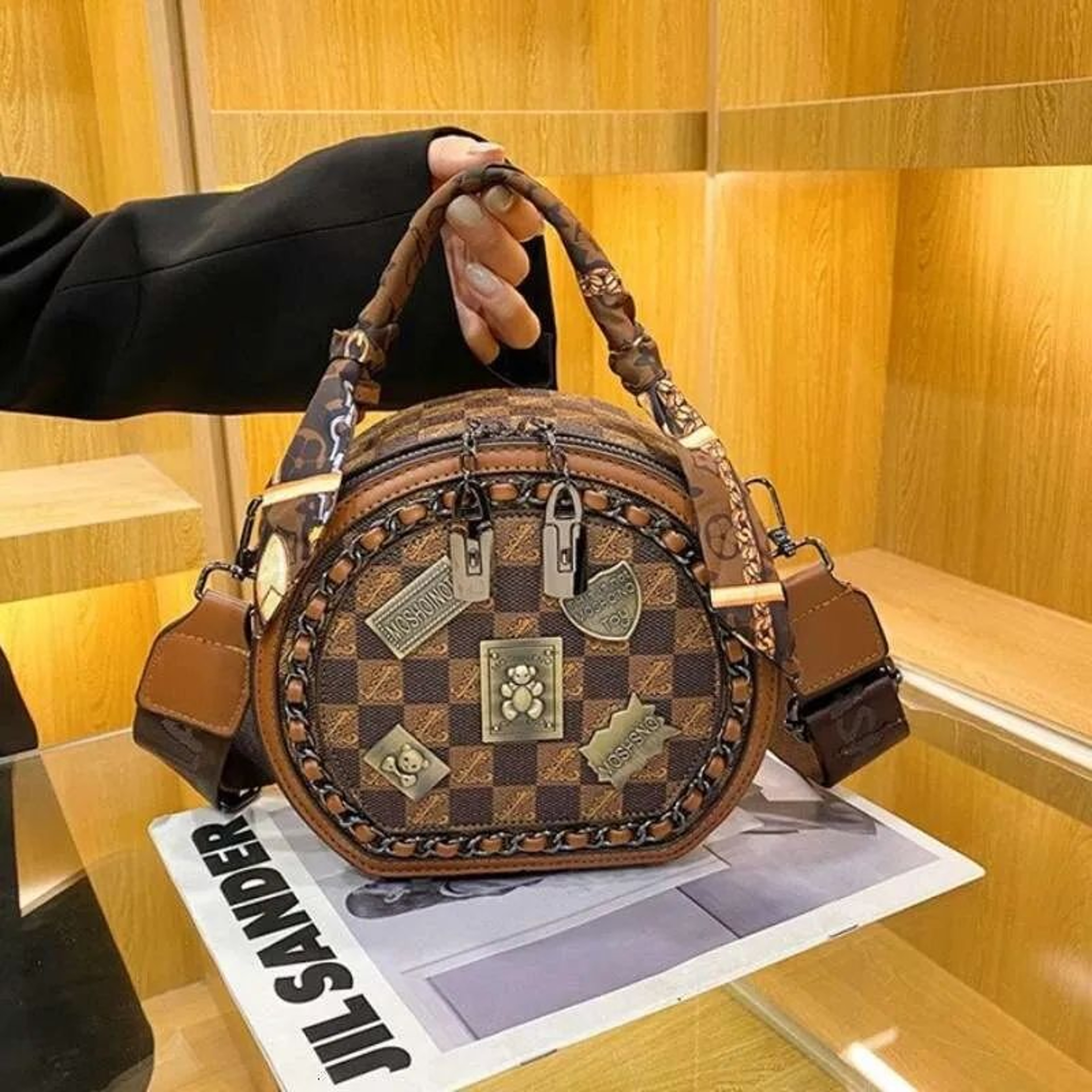 Women Small Round Crossbody Bag With Adjustable Wide Strap And Badge Detail 0