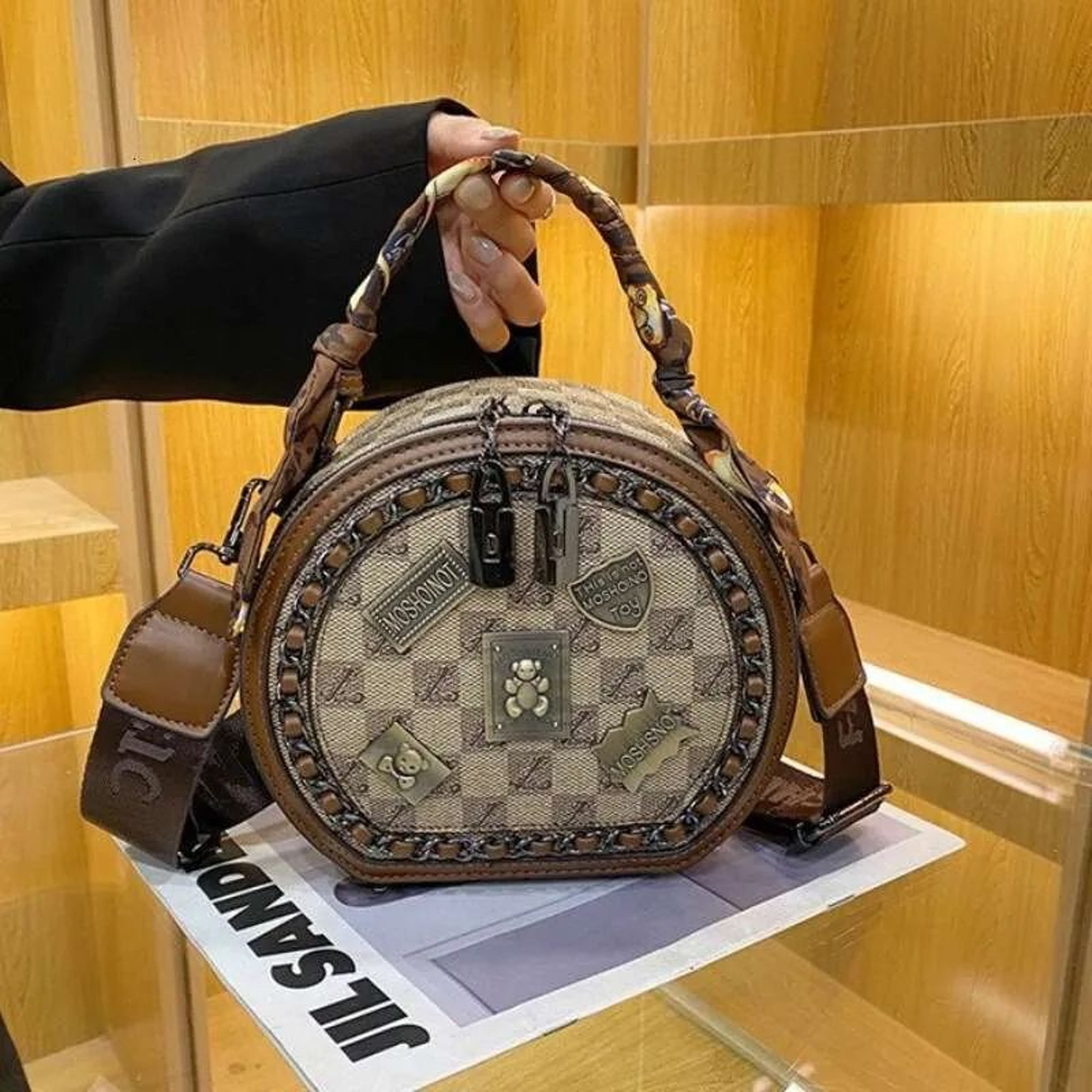 Women Small Round Crossbody Bag With Adjustable Wide Strap And Badge Detail 1
