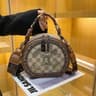Women Small Round Crossbody Bag With Adjustable Wide Strap And Badge Detail 1